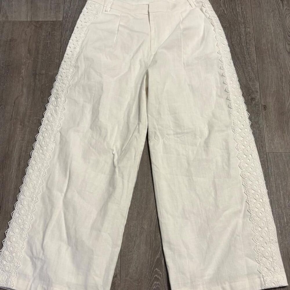 Altar'd State white wide leg pants with lace trim along the outer seams